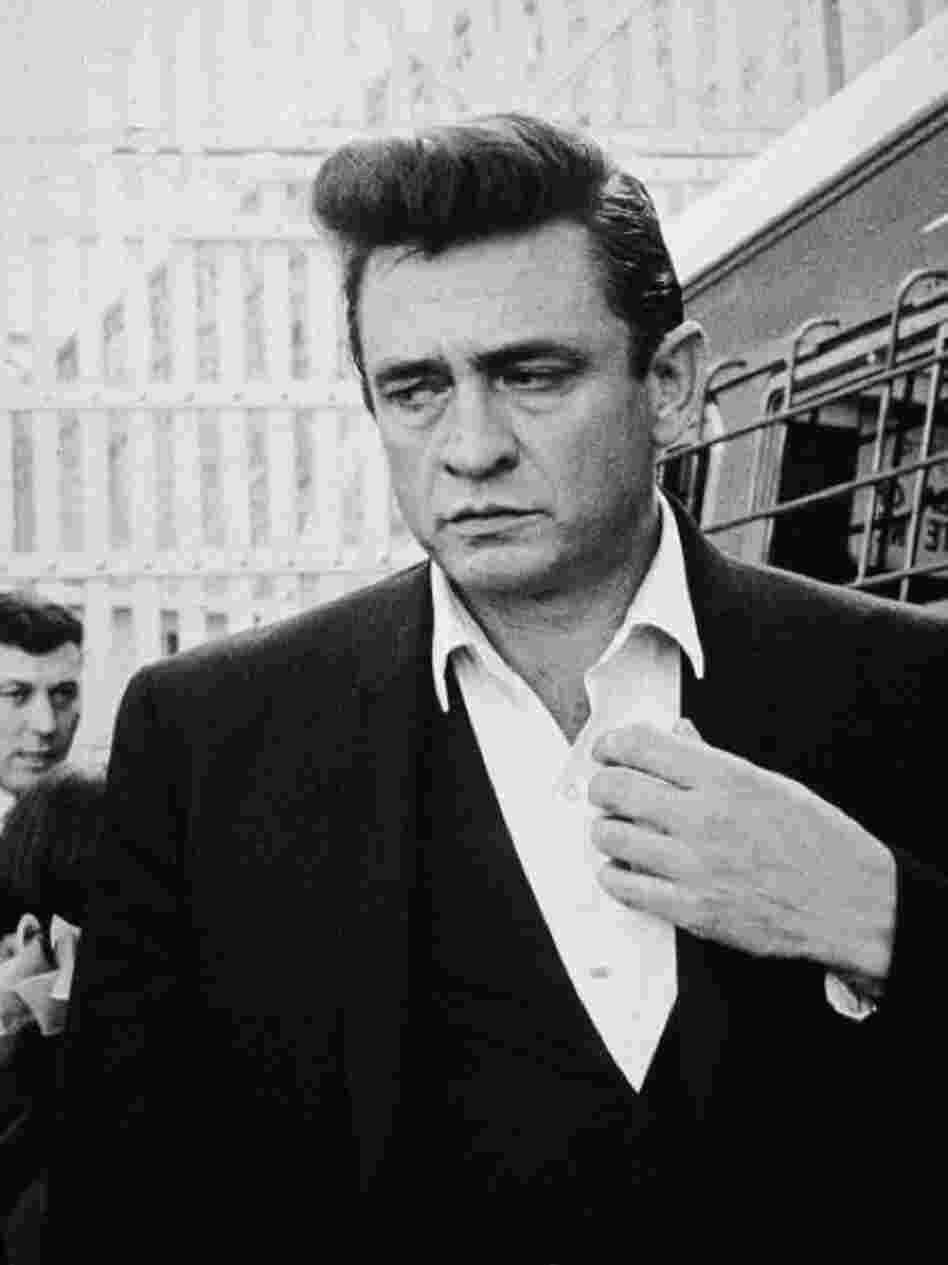 American country singer and songwriter Johnny Cash (1932-2003) walks inside Folsom on his way to perform for inmates there in 1964. 