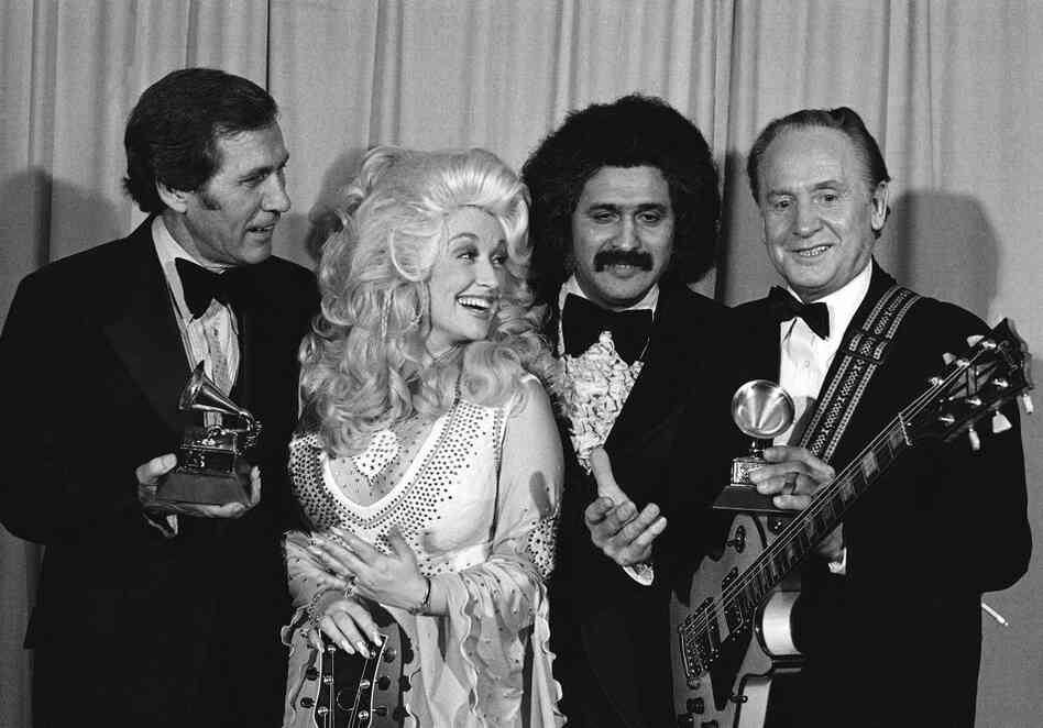 Paul and Chet Atkins (left) are presented Grammies by Dolly Parton and Freddie Fender at 19th annual Grammy Awards in Los Angeles on Feb. 19, 1977. Paul continued to win awards for his music well into the later years of his life. He was in the hospital in February 2006 when he learned he had won two Grammys for an album released after his 90th birthday, Les Paul & Friends: American Made, Wor...