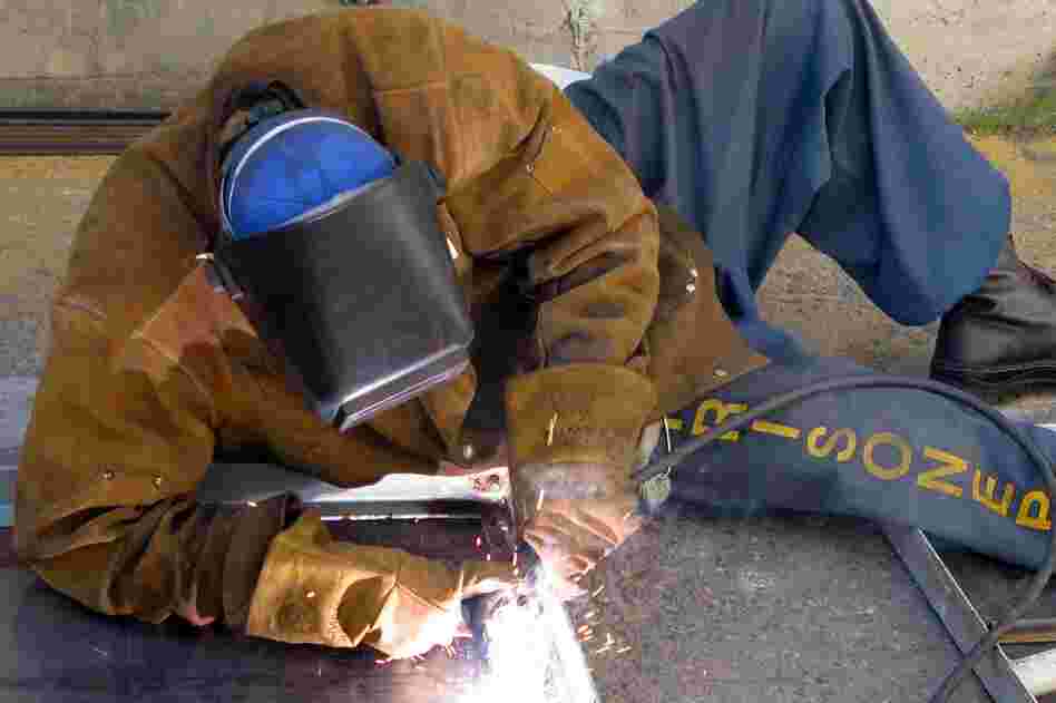 A prisoner welds bunks that will be used for future inmates. His labor saves the prison money and will help to secure his own employment after he leaves prison. 