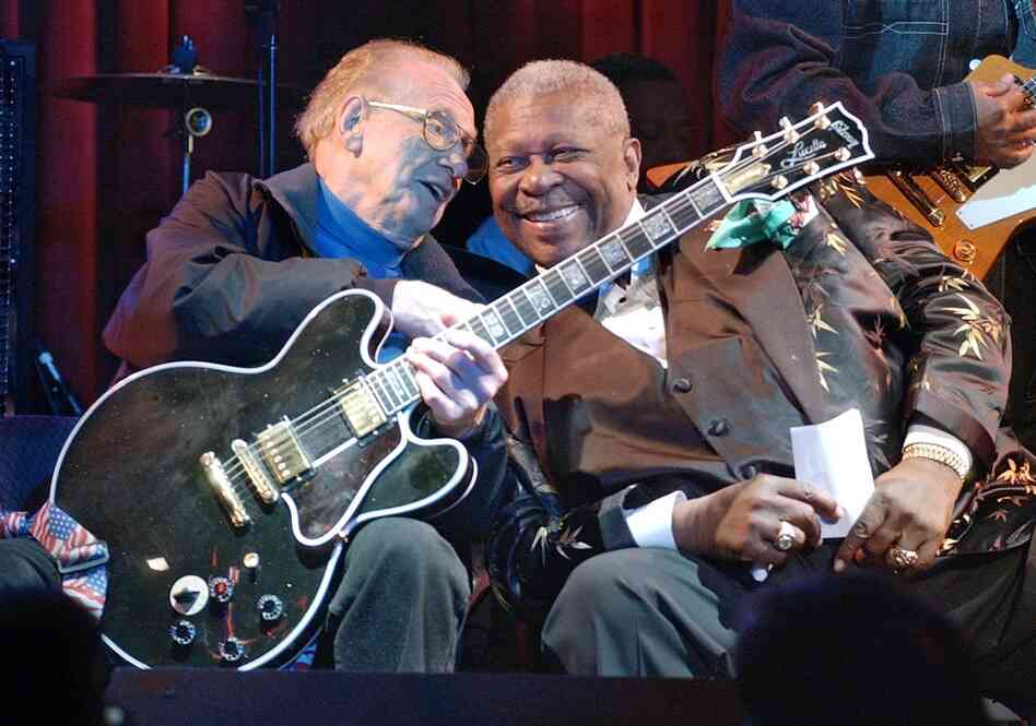 Paul and blues guitarist B.B. King put their heads together during a jam session at the third anniversary celebration of the B.B. King Blues Club and Grill in New York's Times Square, June 17, 2003. Paul holds King's signature guitar, "Lucille,"  which he played. 