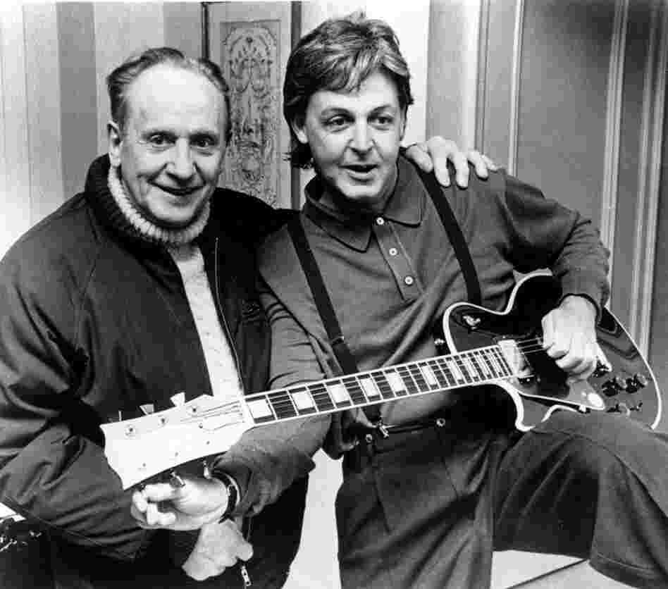 Former Beatle Paul McCartney tries out a custom-made left-handed "Les Paul Lite" guitar presented by Paul himself, in New York City on May 1, 1988. Gibson Guitars began producing the Les Paul guitar in 1952. 