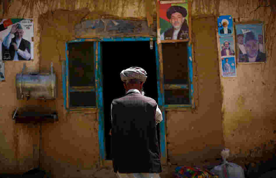 Posters of Afghan President Hamid Karzai are taped to the side of the only restaurant in Yangam district. In this Tajik-dominated ethnic region of Afghanistan, politics take center stage as the presidential election draws near.