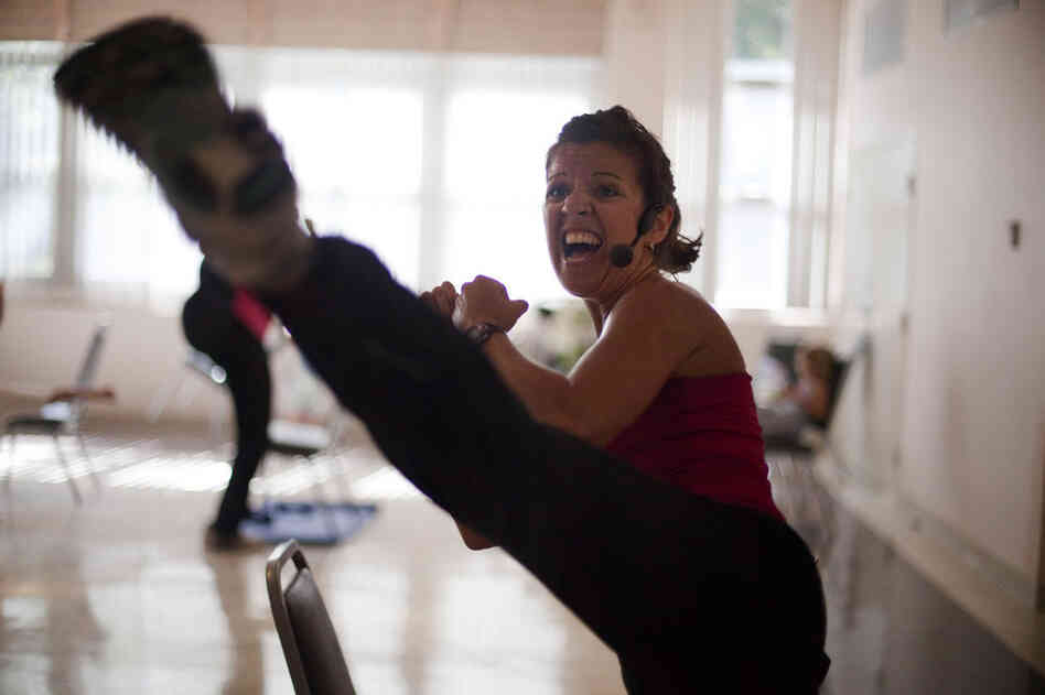 "Be fierce!" Oleson encourages her students while leading a series of kick routines.
