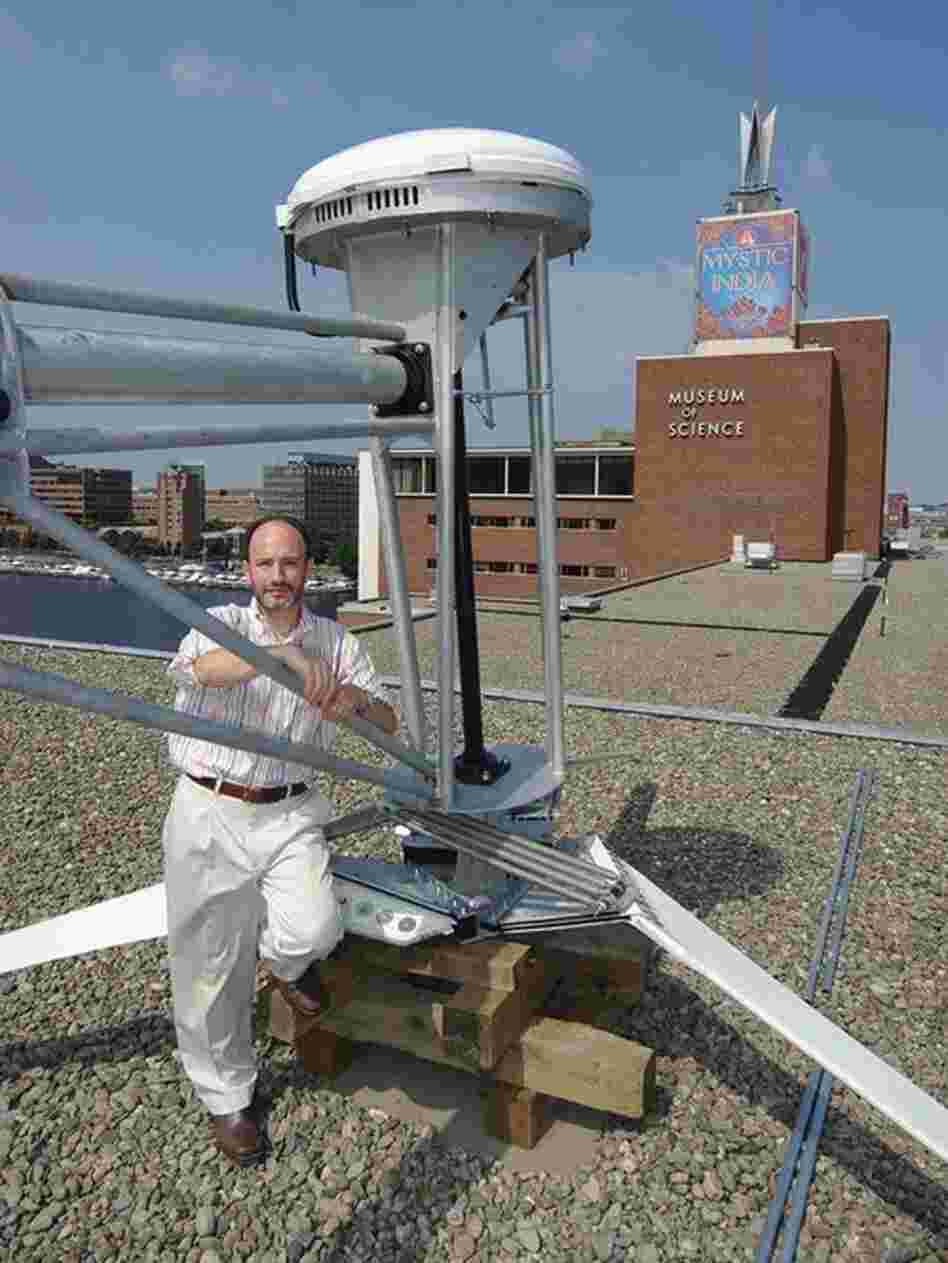 David Rabkin, Farinon Director for Current Science and Technology at the Museum of Science in Boston, stands on the museum's roof with the Proven 6 wind turbine that is yet to be installed. Credit: Museum of Science