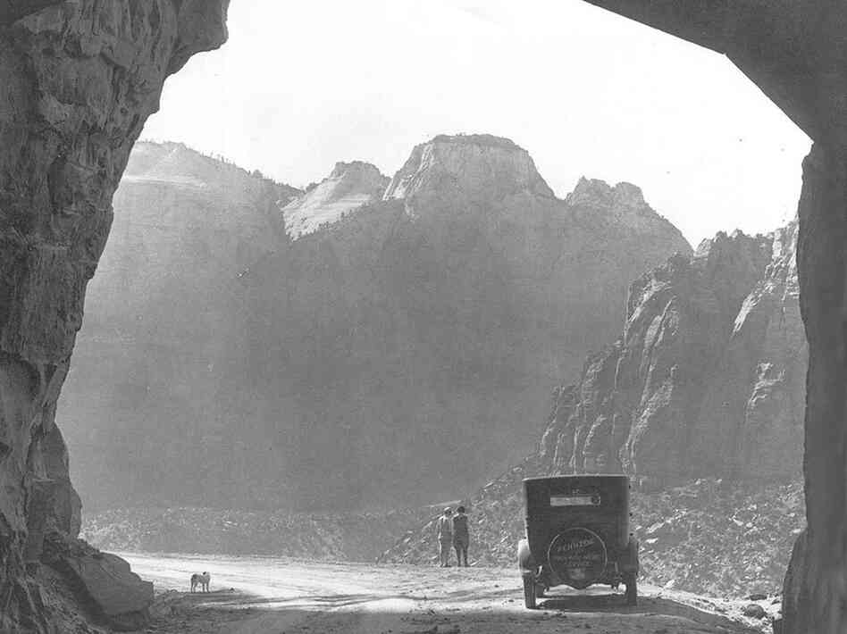 Early visitors stop at the west entrance of Zion Tunnel and take in the view. The tunnel itself is pitch black, except for the sections with windows, and pedestrians are prohibited. Credit: O.M. Uhl