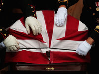 The honor guard places an American flag on the coffin of Sen. Edward Kennedy outside of the Basilica of Our Lady of Perpetual Help after Kennedy's funeral Mass.