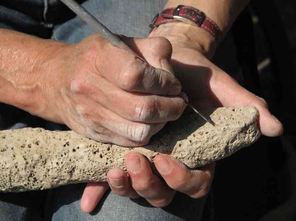 This student hand carves a piece that she's made.  It's meant to imitate undersea coral.