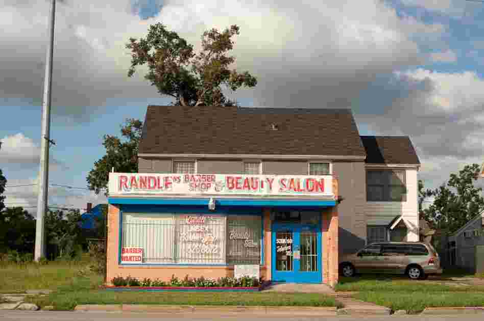 During the 1960s and '70s, the Third Ward lost much of its economic traffic because of racial integration and the move of many African-Americans to the suburbs. Here, a beauty salon attached to a house displays a "help wanted" sign in the window.