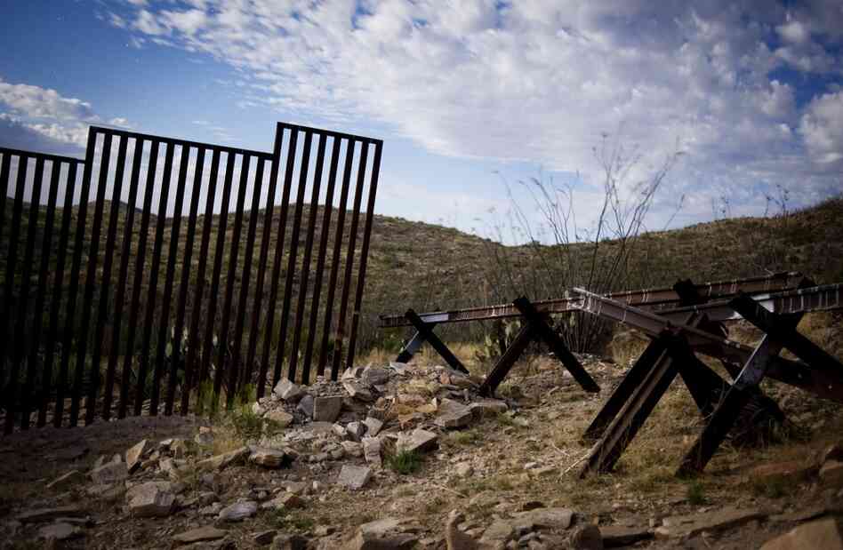 The pedestrian fence ends a few miles from the port of entry at Sasabe, Ariz. To the right are barriers designed to keep vehicles from crossing. Nearly 700 miles of walls and barriers have been built along the U.S.-Mexican border. Desert and mountain ranges remain open and are now major crossing points for drug smugglers, human traffickers and migrants.