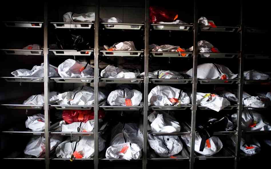 Rows of body bags containing remains of unidentified people found in the desert sit in a cooler outside the Pima County Medical Examiner's Office in Tucson on Aug. 12. The identification process can take years for each body, resulting in an overflowing caseload for the medical examiner.