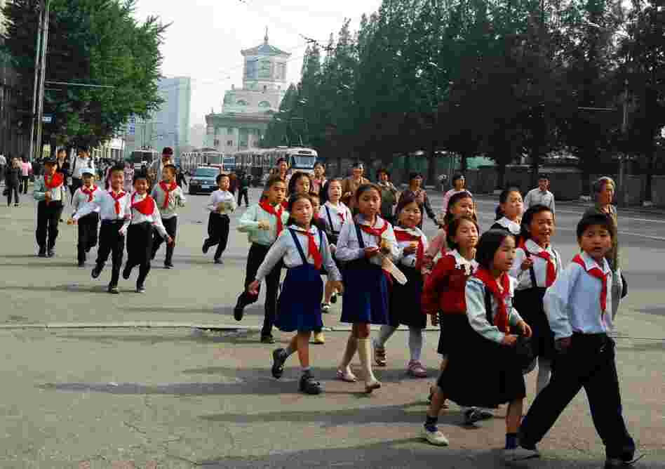 A group of schoolchildren walks along the street outside Yanggwang Station in Pyongyang. 