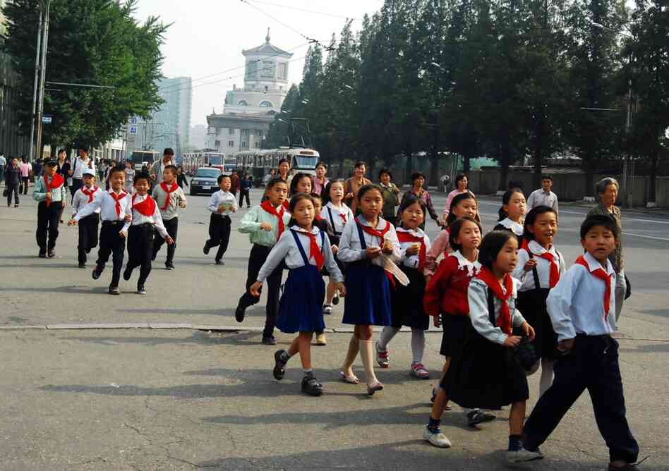 A group of schoolchildren walks along the street outside Yanggwang Station in Pyongyang. 