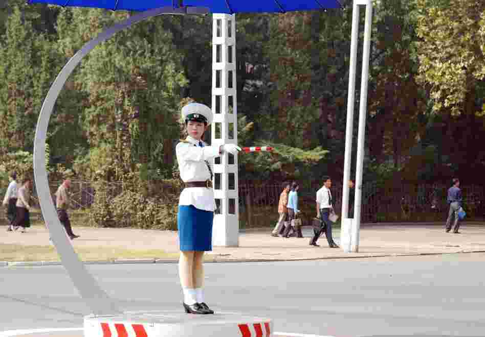 Women, not lights, control traffic in Pyongyang. The female traffic directors stand in demarcated circles in the middle of intersections, and some have umbrellas to shade their faces. 