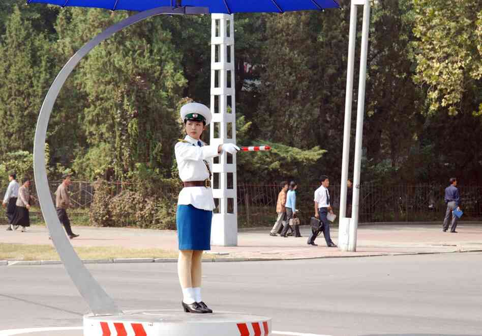 Women, not lights, control traffic in Pyongyang. The female traffic directors stand in demarcated circles in the middle of intersections, and some have umbrellas to shade their faces. 