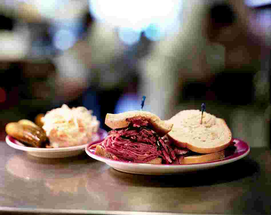 A hot pastrami and corned beef combo sandwich and a side of coleslaw.  Ben's Best sandwiches contain more than 10 ounces of meat.