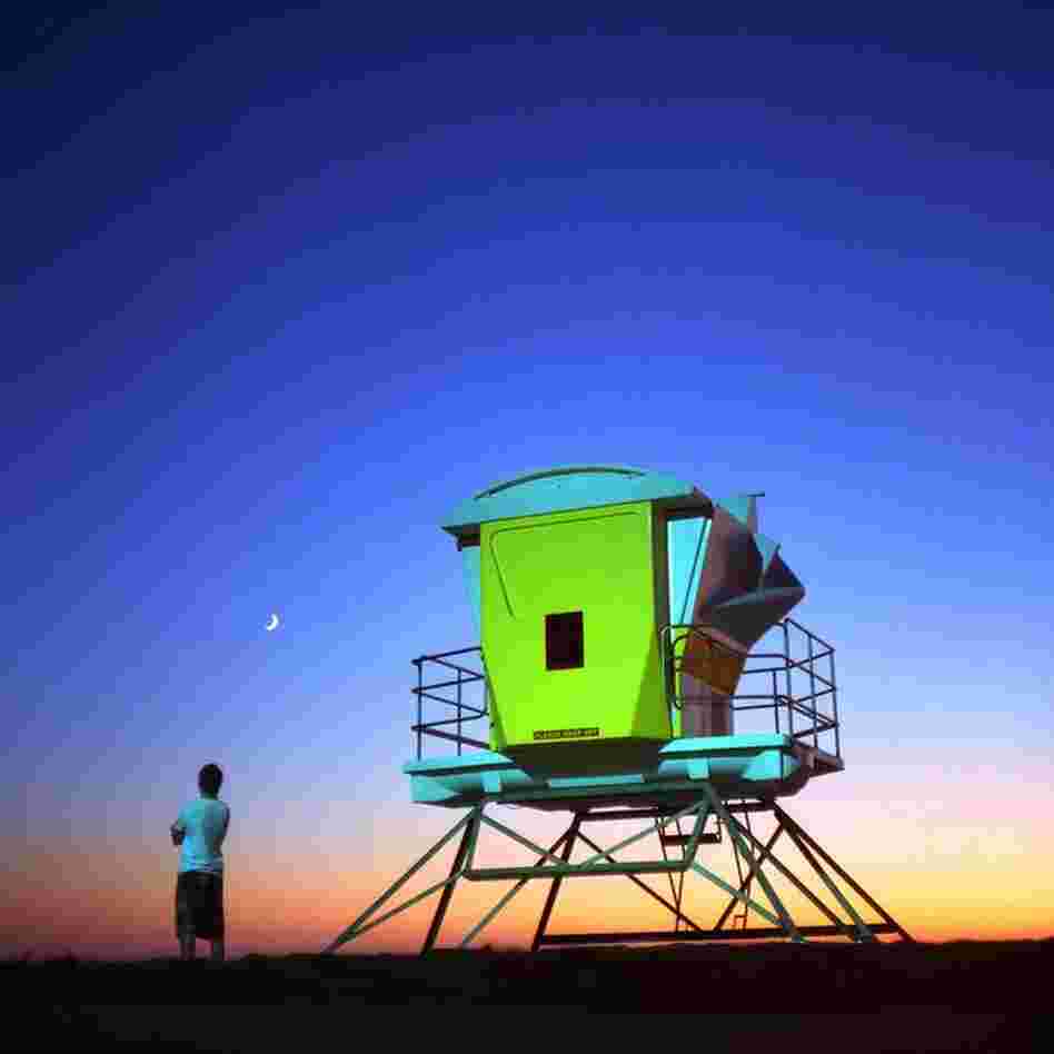 "Lifeguard Hans Fernan surveys the skies above Imperial Beach, Calif." 