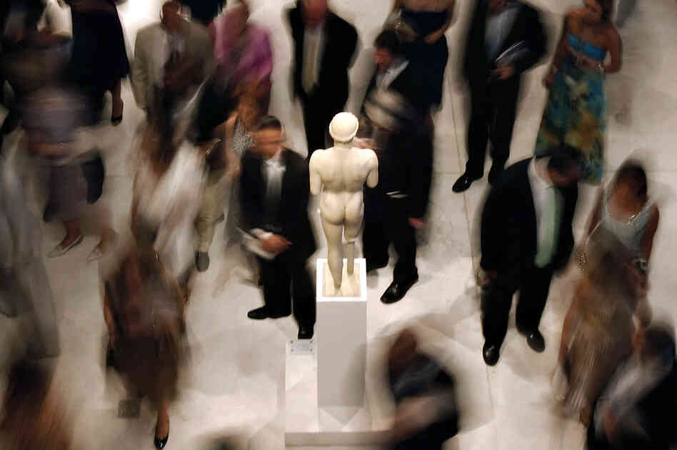 Officials and dignitaries tour the museum at its official opening in June. Greek officials say the museum should also display multiple sculptures that were first removed from the Parthenon frieze 200 years ago by Lord Elgin and later sold to the British Museum. 