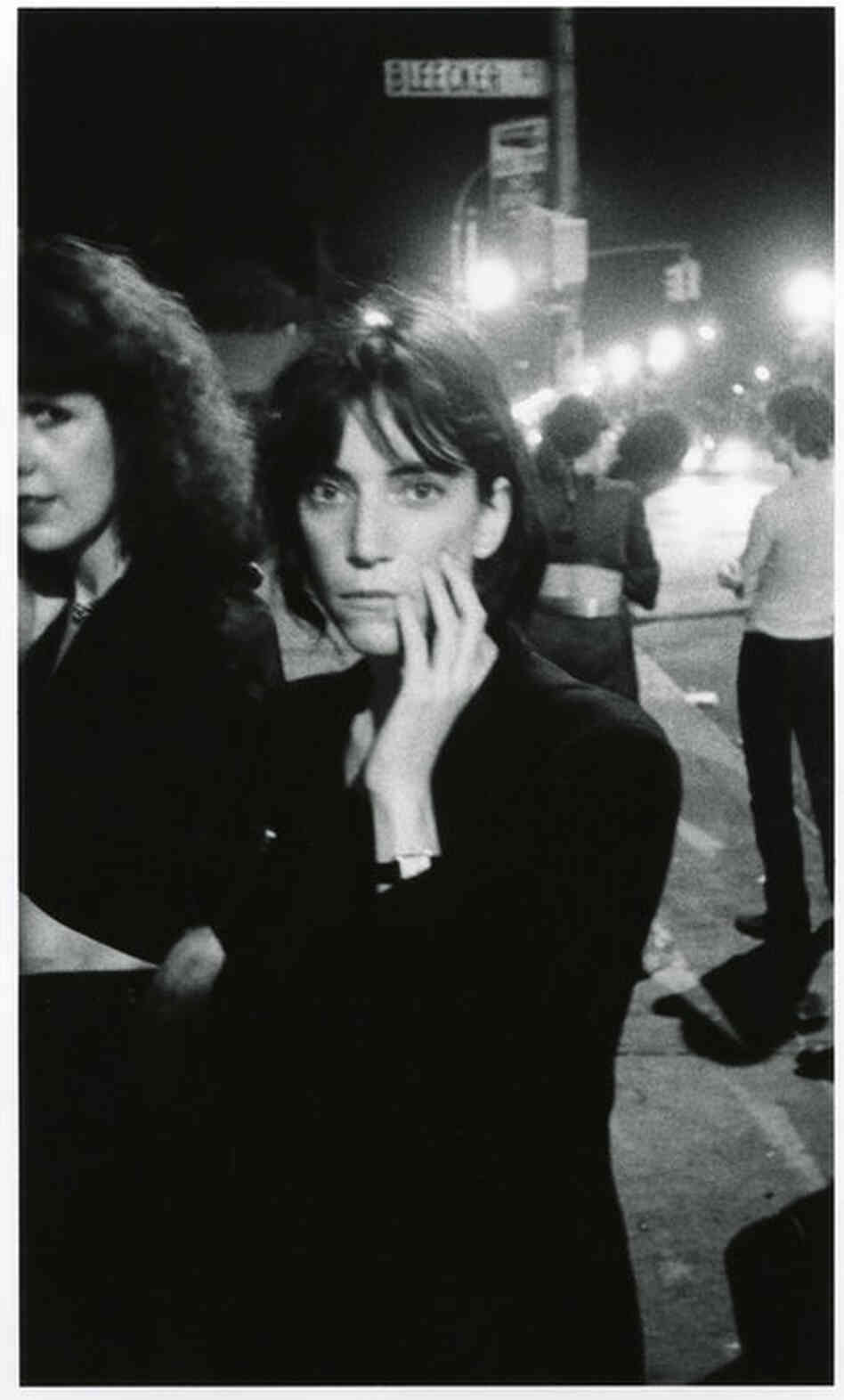 Patti Smith outside CBGB, Bowery and Bleecker Street, New York City, 1976. "In between sets at CBGB, everyone stood out on the Bowery to get fresh air. It was so picturesque, and it was there that I took many of my photographs. It was like my own photo studio." 