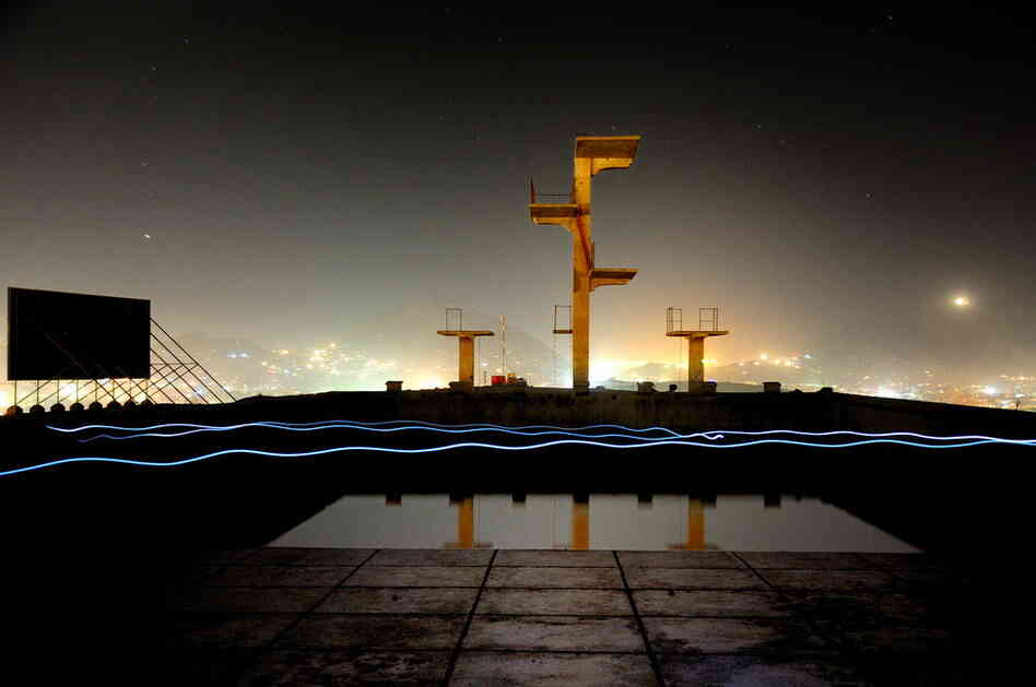 "A self portrait running back and forth with a Petzl headlamp in an old Russian-built swimming pool that sits atop a hill in Kabul City, Afghanistan, February 2009." 