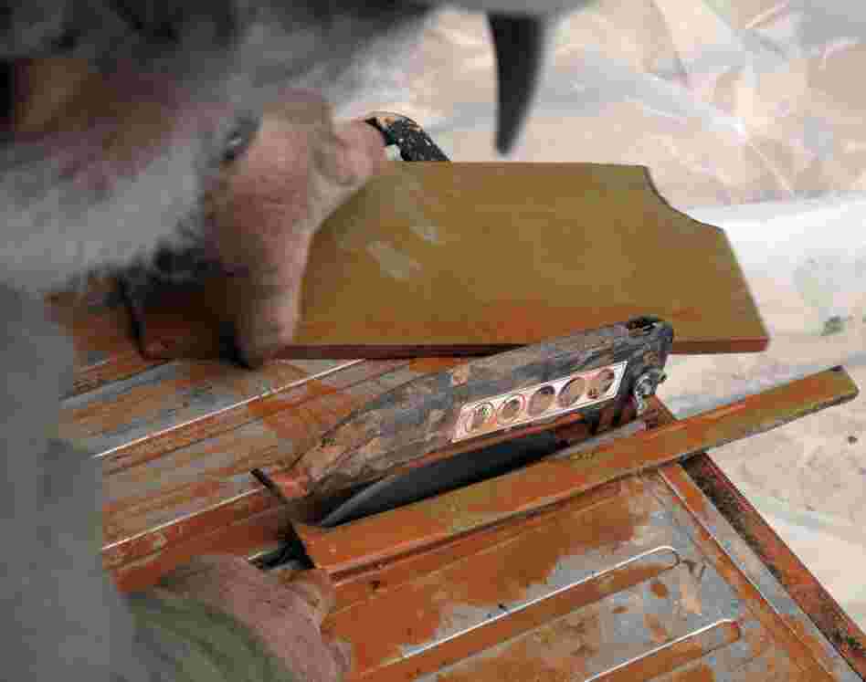 Tulio then takes the marked spacer tiles and cuts them to fit the scene.