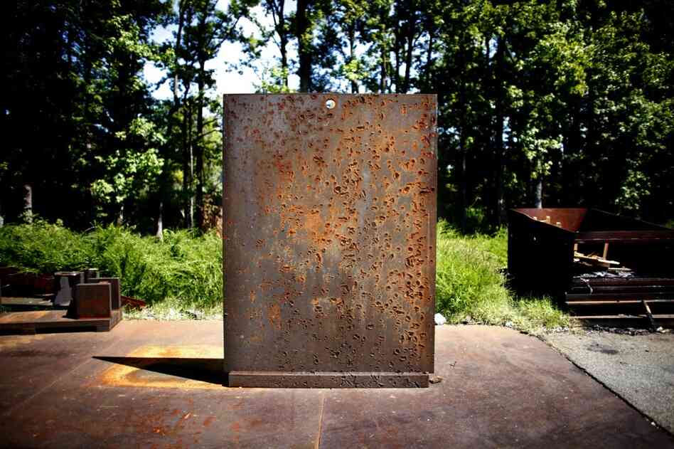 A scarred blast wall bears witness to the thousands of munitions exploded here over the years.