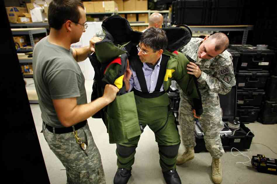 NPR reporter Bruce Auster tries on an 85-pound bomb suit worn by explosives specialists in Iraq and Afghanistan to approach and defuse bombs.