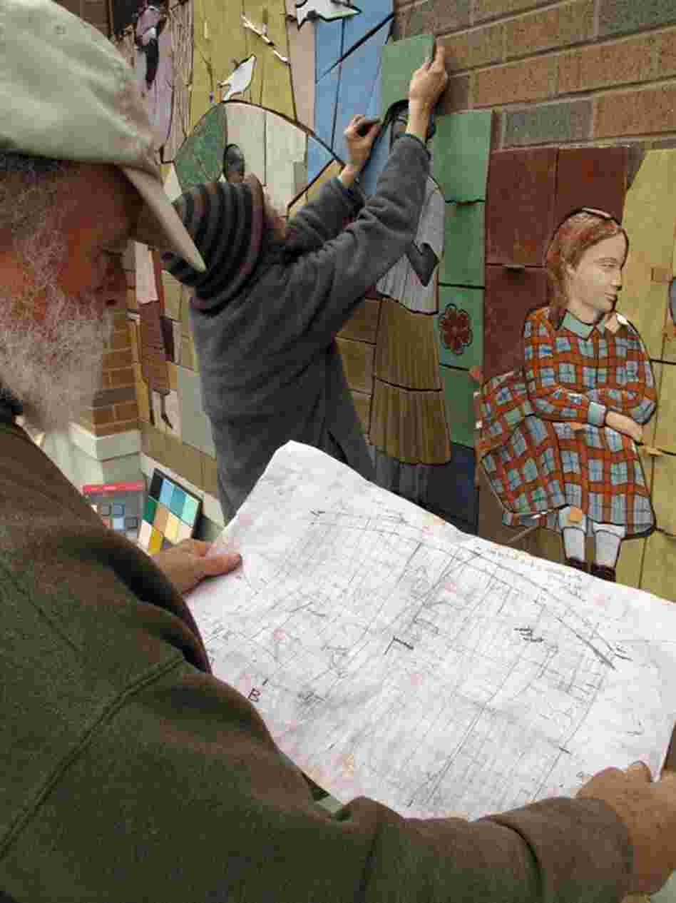 The artists drove the tiles down from their home in Massachusetts. Each section of the mural is pre-arranged on large wood palettes and glued onto the wall.