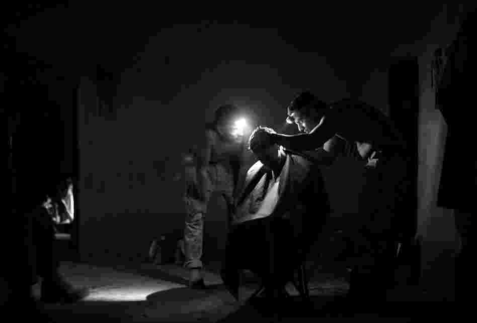 After a long day, Quiceno gives a fellow Marine a haircut.
