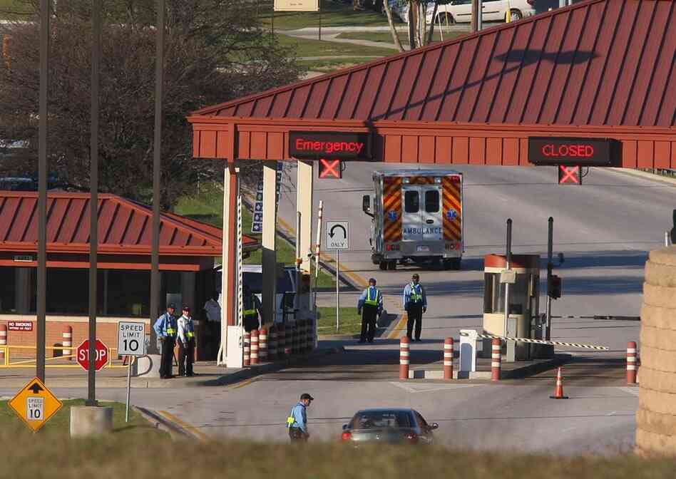 An ambulance passes the main gate at Fort Hood following the shooting. 
