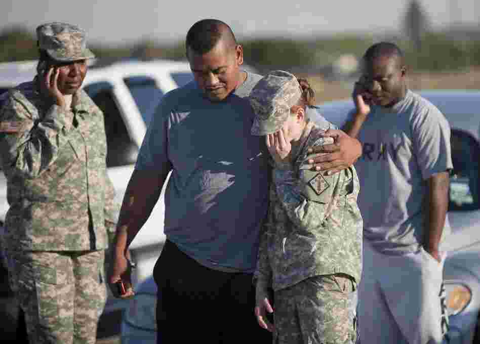Sgt. Fanuaee Vea (center) embraces Pvt. Savannah Green outside the base. 