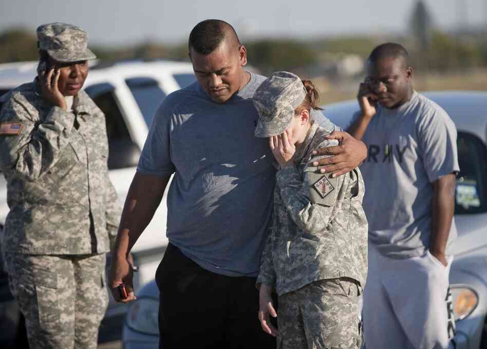 Sgt. Fanuaee Vea (center) embraces Pvt. Savannah Green outside the base. 