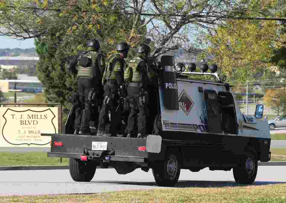 A SWAT team enters the main gate at Fort Hood. The shooting occurred at the Soldier Readiness Center, where troops deploying to Iraq and Afghanistan receive last-minute medical checkups. 