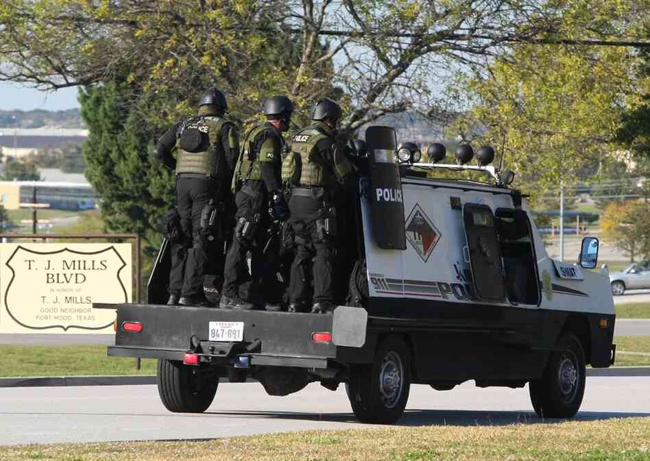 A SWAT team enters the main gate at Fort Hood. The shooting occurred at the Soldier Readiness Center, where troops deploying to Iraq and Afghanistan receive last-minute medical checkups. 