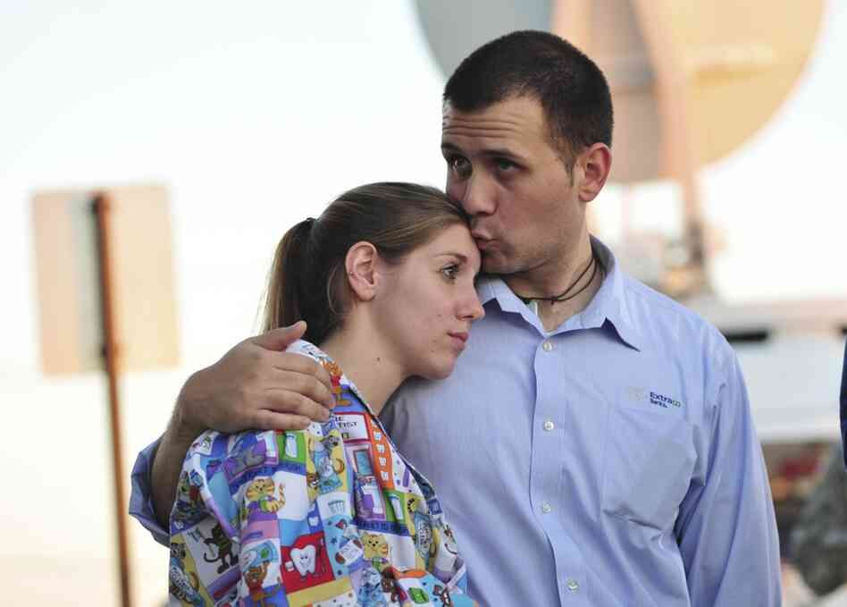 Daniel Clark kisses his wife, Rachel Clark, while they wait for Fort Hood to reopen after Thursday's shooting so they can pick up their 5-year-old child at a day care center. 