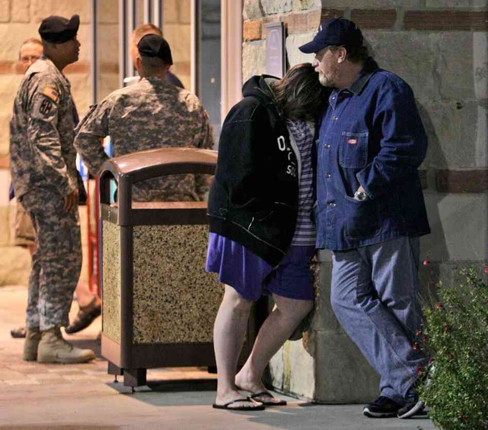 Jamie Casteel and her husband, Scotty, of Duncan, Okla., wait to hear news about their son-in-law Thursday outside the Scott and White Hospital emergency room in Temple, Texas.  