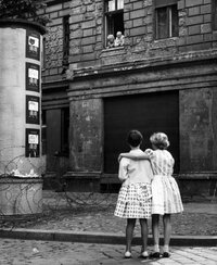 The Berlin Wall did not only divide a city; in many cases it split families. In this photo taken on Aug. 14, 1961, two children in a West Berlin street speak with their grandparents through their window in East Berlin.