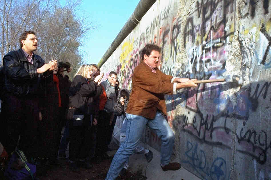 An unidentified West Berliner swings a sledgehammer at the wall near Potsdamer Platz, on Nov. 12, 1989. 