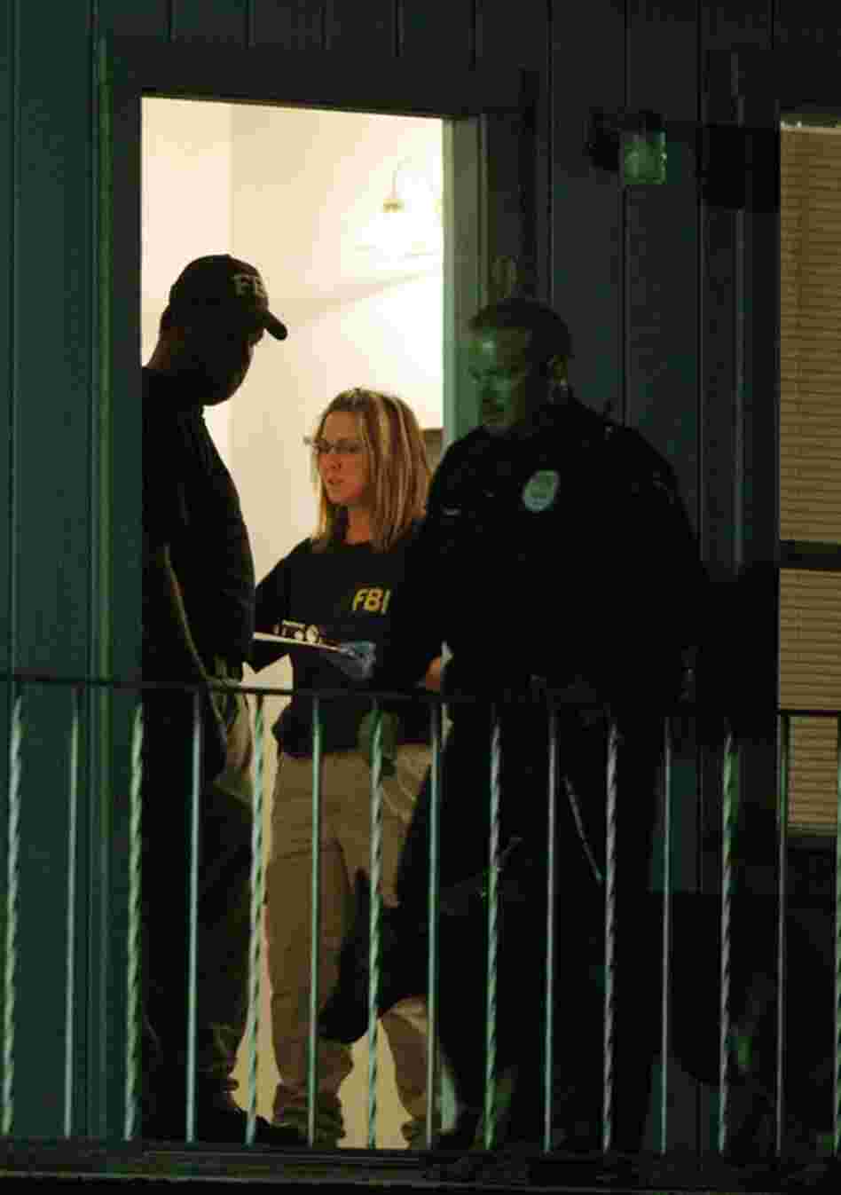 Federal agents search Hasan's apartment in Killeen early Friday. Hasan, an Army psychiatrist, was unconscious and on a ventilator Friday, contrary to early reports that he had been killed. 