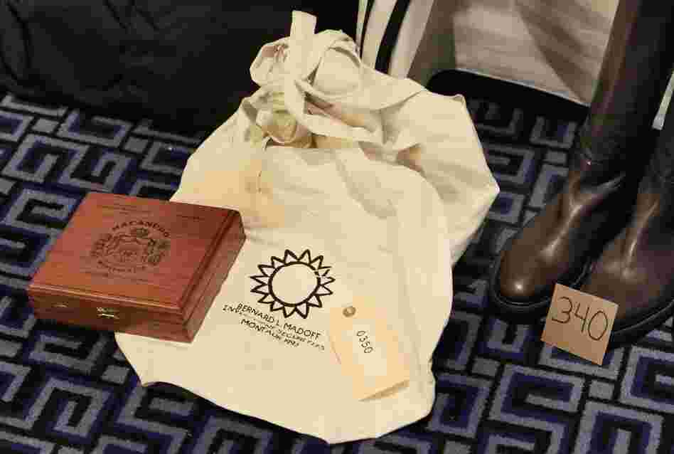 Three monogrammed beige canvas duffel bags with "Bernard L. Madoff Investment Securities Montauk 1993" and a Macanudo cigar box. 
