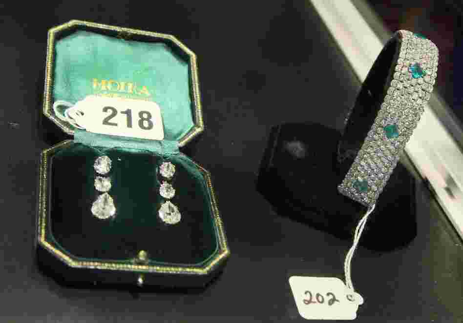 Silver pre-Victorian diamond earrings and a platinum Edwardian-era diamond and emerald bracelet. 