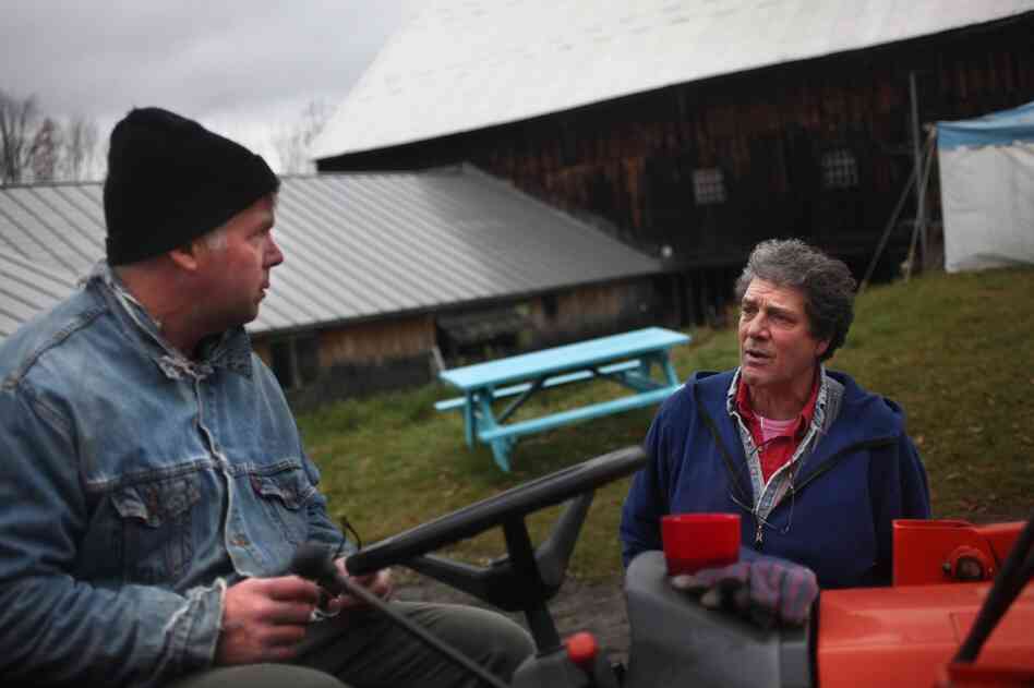 Wood (right) gives Jeff Williams last-minute instructions before Williams goes to work in one of the orchards. Wood thought it was going to be an easy day, but it quickly turned busy. "You can never tell what your day's going to be like — keeps all of us on our toes," he said.