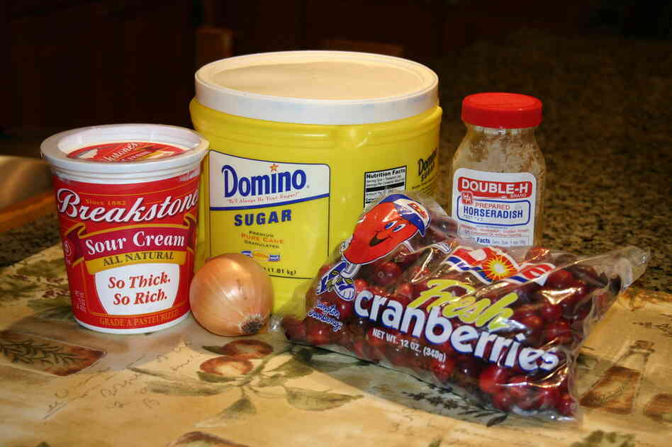 The ingredients: 2 cups whole raw cranberries; 1 small onion; 3/4 cup sour cream; 1/2 cup sugar; 2 tablespoons horseradish from a jar—white or red.