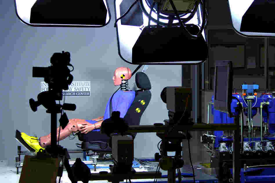 A dummy is used in a demonstration test of seat-back head restraints at the IIHS. 