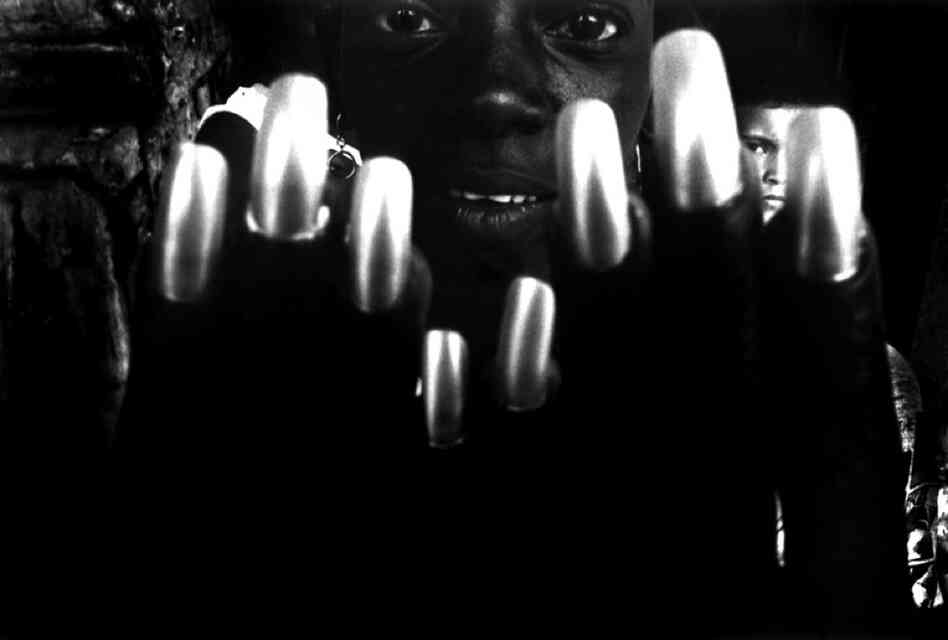 As a girl shows off her nails, another girl appears between them.