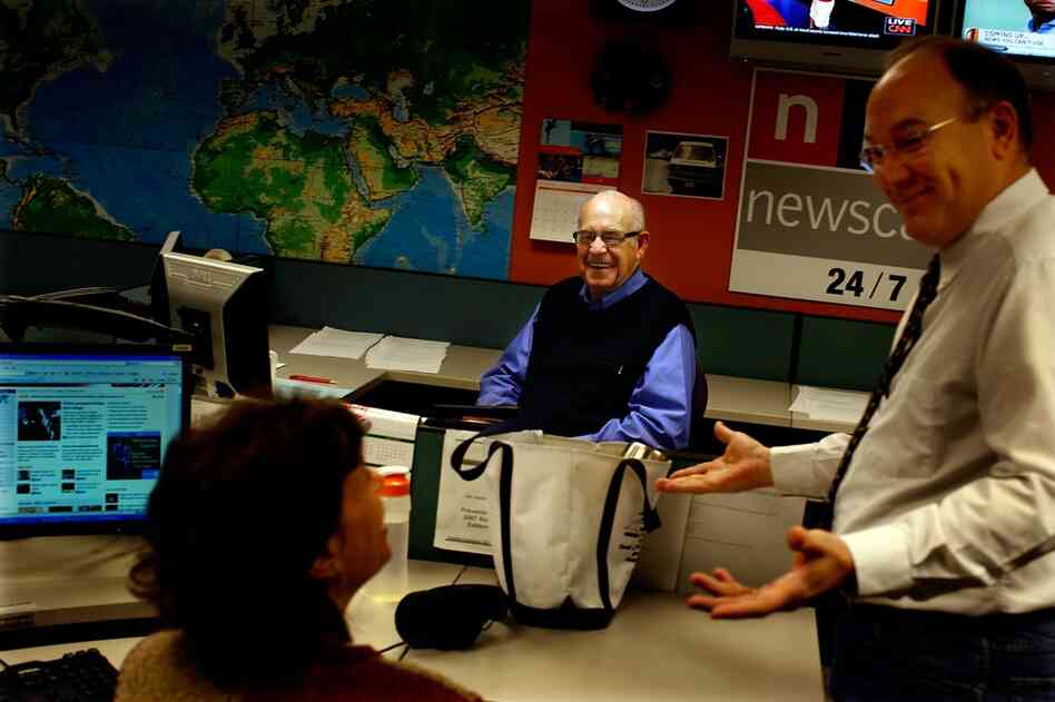 On Dec. 29, Kasell discusses a newscast with senior producer Dave Pignanelli (right) and fellow newscaster Barbara Klein. Kasell regularly arrived at work at 2 a.m.