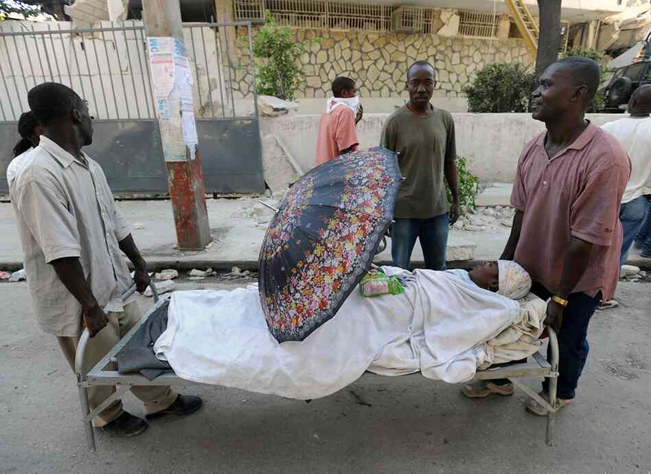 Men carry an injured relative in Port-au-Prince. The Haitian Red Cross estimates that more than 50,000 people may have been killed in the earthquake. 