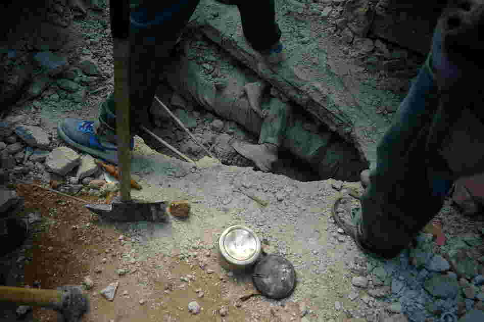 Workers dig for bodies in a fight against time. 