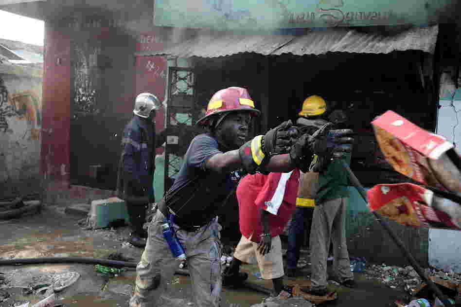 Fireman attempt to put out a blaze in Port-au-Prince Thursday. 
