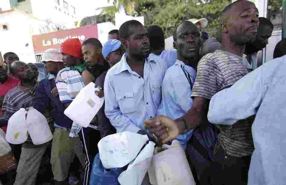 People line up to for gasoline. Aid organizations are struggling  to get needed resources to survivors. 