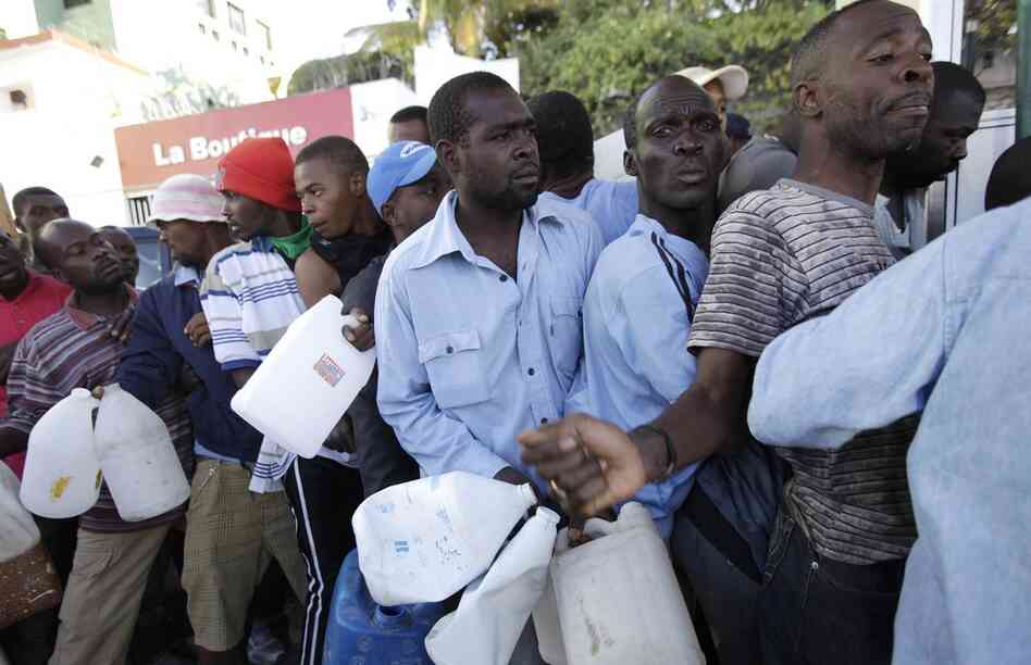 People line up to for gasoline. Aid organizations are struggling  to get needed resources to survivors. 